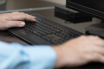 Hands typing on keyboard
