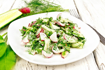 Salad of radishes and sorrel with mayonnaise in plate on light board