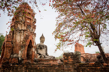 Aged abandon temple and buddha in Ayutthaya, the national historical place of Thailand.