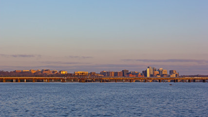 Washington DC panorama across Potomac River at sunrise. Transport artery connecting downtown with Virginia suburbs of metropolitan area.