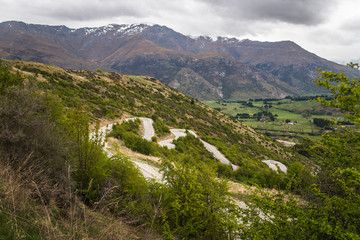 A winding road in the middle of the mountains near Queenstown, New Zealand. 