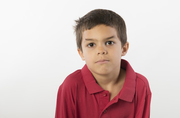 Sweet little boy with serious expression, isolated on white background
