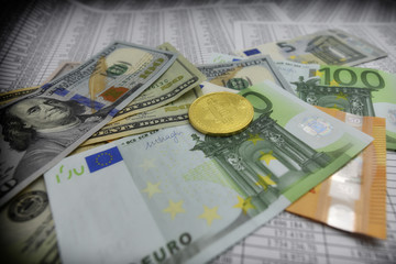 coin bitcoin lies on banknotes and sheets with numbers