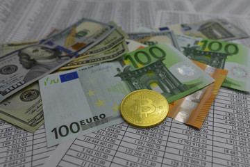 coin bitcoin lies on banknotes and sheets with numbers