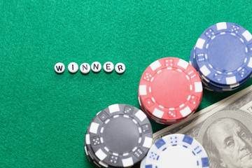 word "winner" with poker chips and money, gambling concept
