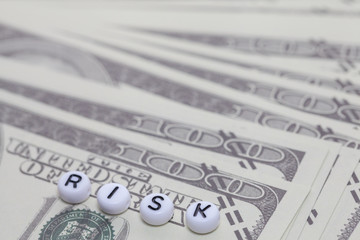 word "risk" with dollar money , gambling concept