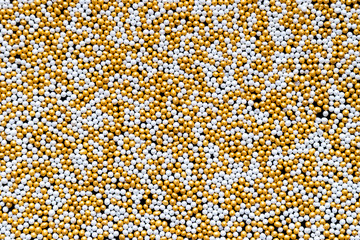 White, Gold, Shiny and Tiny Sugar Balls Background With Free Space