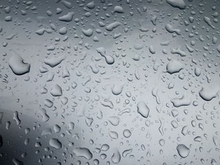 Rain Drops on the Surface of the Car or on the Iron Surface Flow Down. Abstract Background and Water Texture for Design.