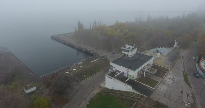Aerial view of abandoned river station building on river bank, Central Europe, Ukraine