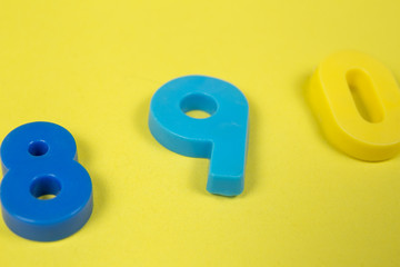 Plastic numbers оne two on a yellow background