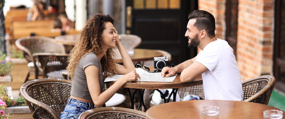 Beautiful loving couple sitting in a cafe enjoying in coffee