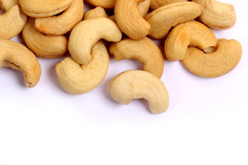 Unshelled roasted and salted cashew nuts isolated on white background