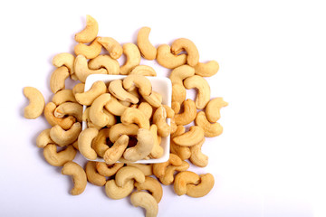Unshelled roasted and salted cashew nuts isolated on white background