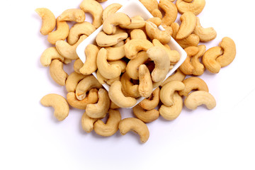 Fototapeta premium Unshelled roasted and salted cashew nuts isolated on white background
