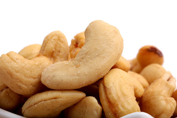 Fototapeta na wymiar Unshelled roasted and salted cashew nuts isolated on white background