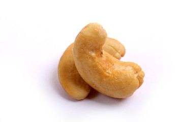 Unshelled roasted and salted cashew nuts isolated on white background