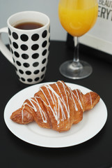 Coffee and Croissants White Chocolate Glass of Orange Juice Breakfast morning Isoalted on Black Table.