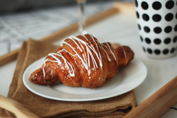 Breakfast in Bed. Coffee and Croissants White Chocolate Food. Cup of Coffe or Tea. Morning light.