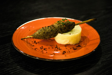 Mashed potatoes - border with cutlet, pork schnitzel on a stick, barbecue, kebab, Russian cuisine,...