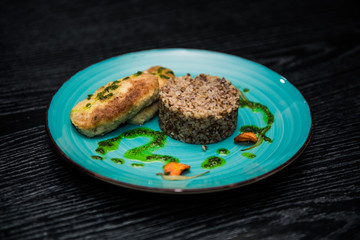 buckwheat porridge with a cutlet on a blue plate. Buckwheat cereal with schnitzel.