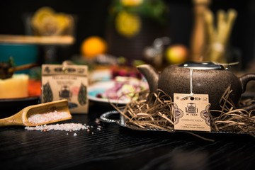 Dinner table with meat grill, roast new potatoes, vegetables, salads, sauces, snacks and lemonade,  selective focus