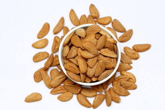 Almond mamra giri isolated. Group of almond nuts isolated on white background. Full depth of field