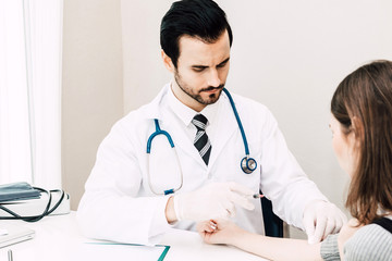 Doctor in protective gloves giving a female patient injection  in hospital.healthcare and medicine