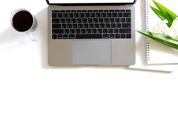 Stylish office table desk. Workspace with laptop, coffee mug and notebook on white background.