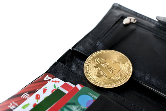 Purse with bitkoin and credit cards close-up.