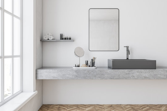 Gray sink in a white bathroom