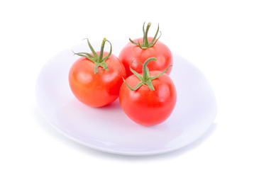 Closeup of tomatoes on white plate isolated