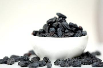 black raisins on white background
