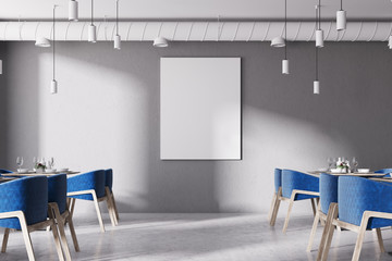 Front view of a loft cafe with blue chairs, poster