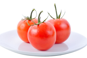 Closeup of tomatoes on white plate isolated