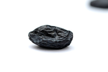black raisins on white background
