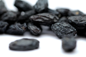 black raisins on white background