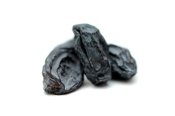 black raisins on white background