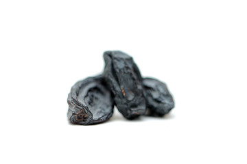 black raisins on white background