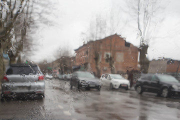 rain on the city street through a car windshield. Rain drops on window, rainy weather