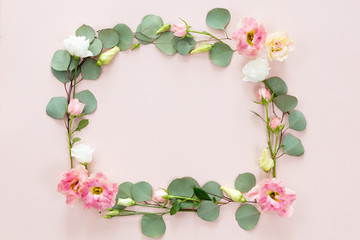 Pink roses on white background. Flat lay. Frame wreath