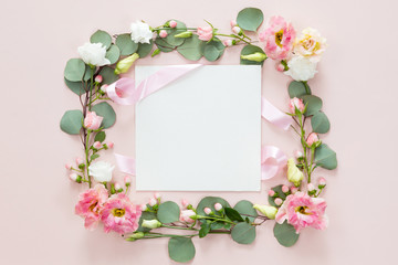 Pink roses on white background. Flat lay. Frame wreath