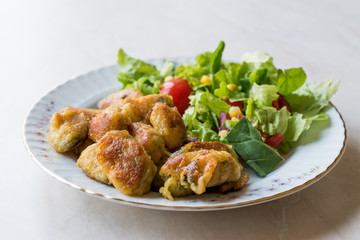 Fototapeta premium Fried Crispy Mussels Served with Salad.