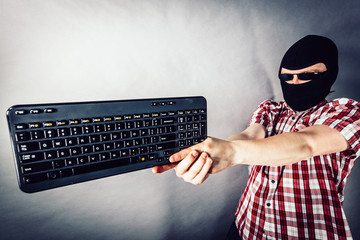 Man wearing balaclava shooting from keyboard