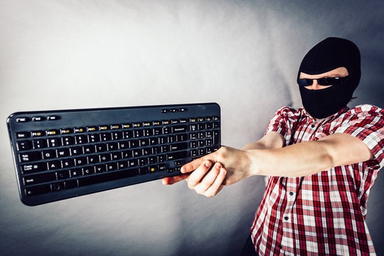 Man wearing balaclava shooting from keyboard