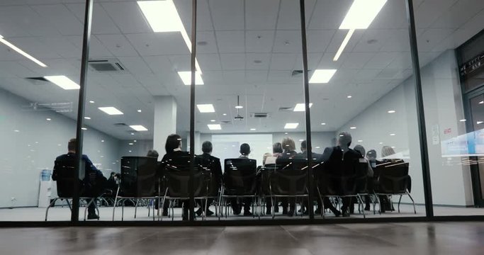people at a conference or presentation, workshop, master class photograph. Business presentation seminar event. Back view