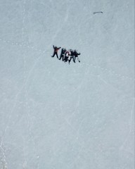 friends lie on ice