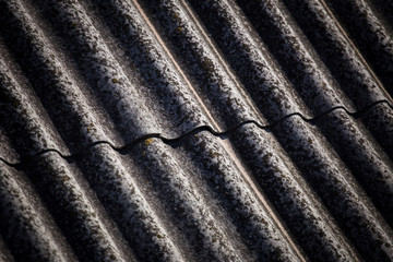 The texture of a voluminous slate on an old roof close up.