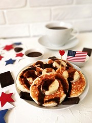 American independence Day, celebration, patriotism and holidays concept-cheesecakes and coffee with flags and stars on 4th of July party on wooden background