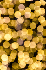 Yellow gold lights, garlands. Blurred photo. Celebratory background.