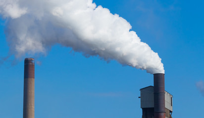 Steam and smoke coming out of a smoke stack